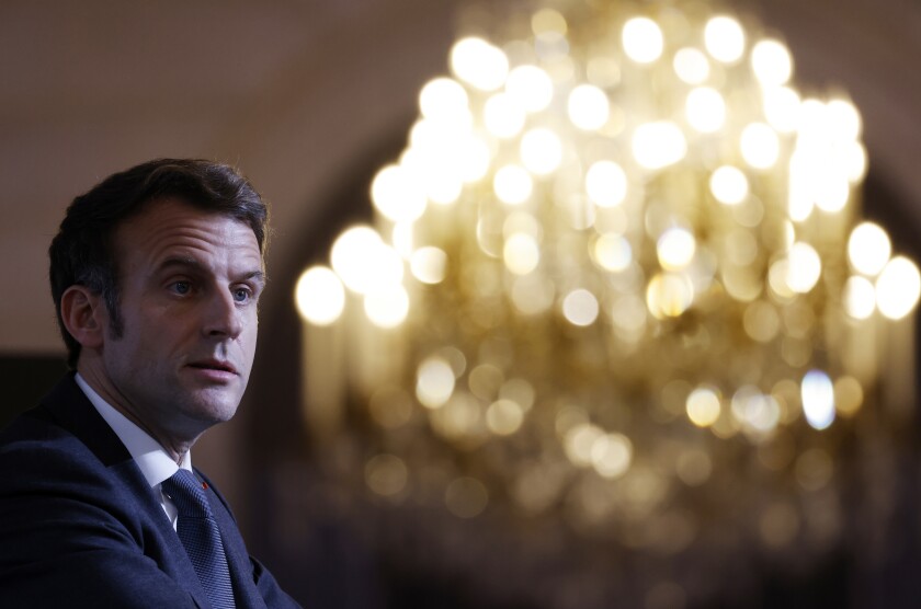 France's President Emmanuel Macron talks with representatives of families of repatriates from Algeria after the country's independence war with its colonial power, at the Elysee palace in Paris, Wednesday Jan. 26, 2022. French President Emmanuel Macron is pushing for dialogue with Russia, despite signs pointing to a potential war amid escalating tensions with Ukraine. It's part of France's post-World War II tradition of carving out its own geopolitical path. Macron is to talk with Russian President Vladimir Putin on Friday morning. (Ludovic Marin, Pool via AP)