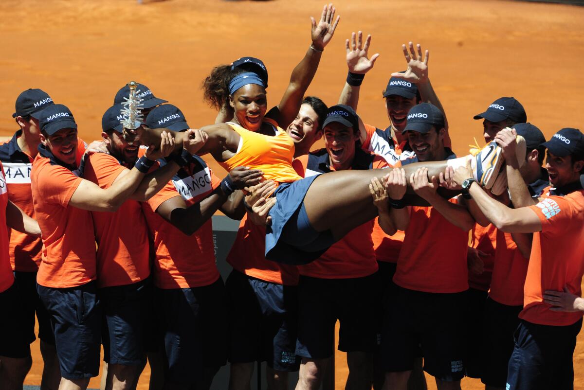 Serena Williams celebrates with Madrid Open volunteers after defeating Maria Sharapova in the final on Sunday.