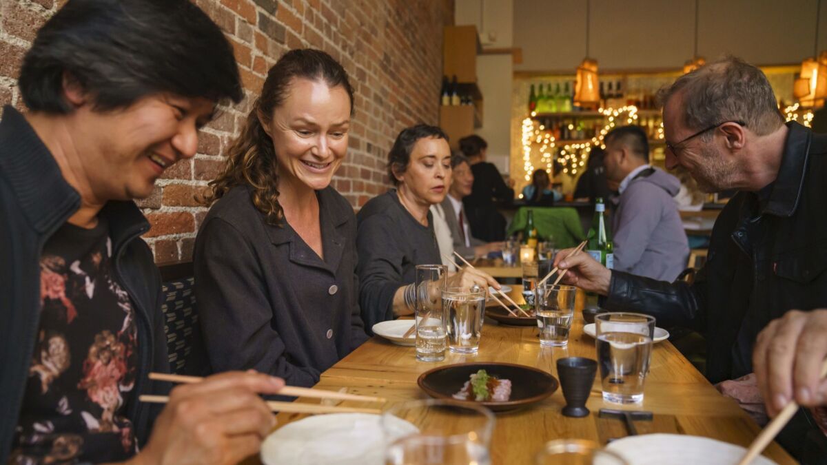 Dennis de Ocampo, from left, Julie Mills, and Pam Leonte dine with friends at Tsubaki, a neighborhood izakaya in Echo Park.
