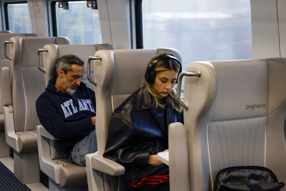 Passengers travel onboard the premium coach of a Brightline train in Miami, 
