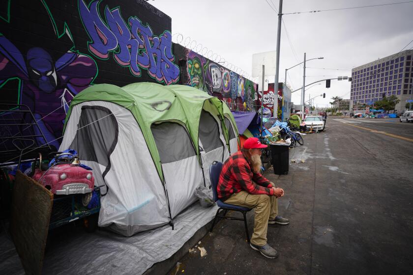 San Diego, CA - June 13: John McCormick who is currently living at the Alpha Project shelter stopped to visit his brother who is living on a street encampment on Commercial Street. Members from the San Diego City Council on Tuesday, June 13, 2023 in San Diego, CA., listen to public comments on the proposed ordinance making it illegal for Unauthorized Camping or Encampments on Public Property. (Nelvin C. Cepeda / The San Diego Union-Tribune)