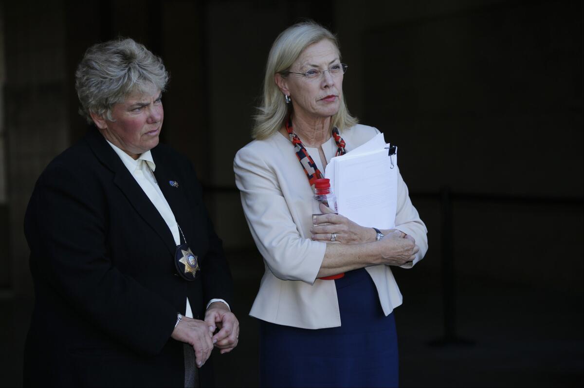CSUN president Dr. Dianne Harrison, right, holds a report regarding Pi Kappa Phi fraternity hazing activities that lead to the death of CSUN student Armando Villa, during a news conference at the CSUN campus in Northridge on Sept. 5.