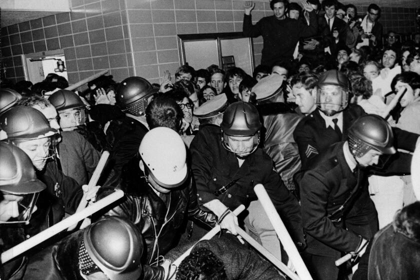 Police use tear gas and night sticks to break up anti-war demonstrations at the University of Wisconsin campus in Madison, Oct. 18, 1967. A sit-in was staged to protest job recruiting on campus by Dow Chemical, maker of napalm for the Vietnam war. Demonstrators and a detective were bloodied in the melee. (AP Photo/Neal Ulevich)