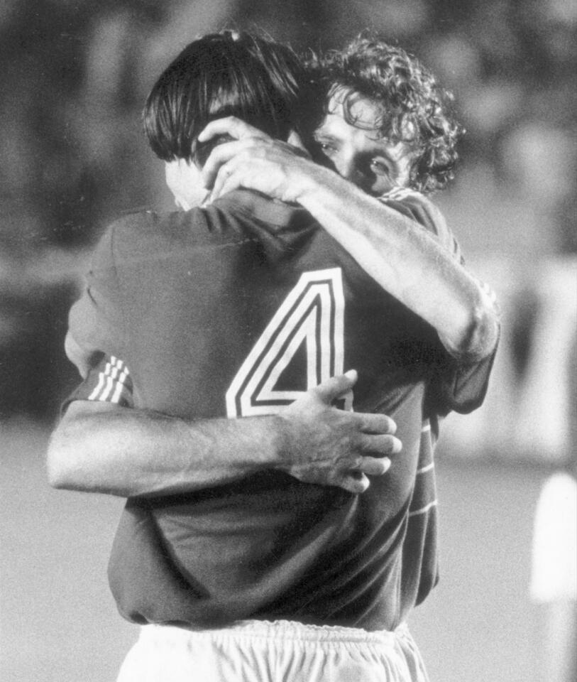 French teammates hug after their 4–2 victory during Olympic Games soccer match at the Rose Bowl.