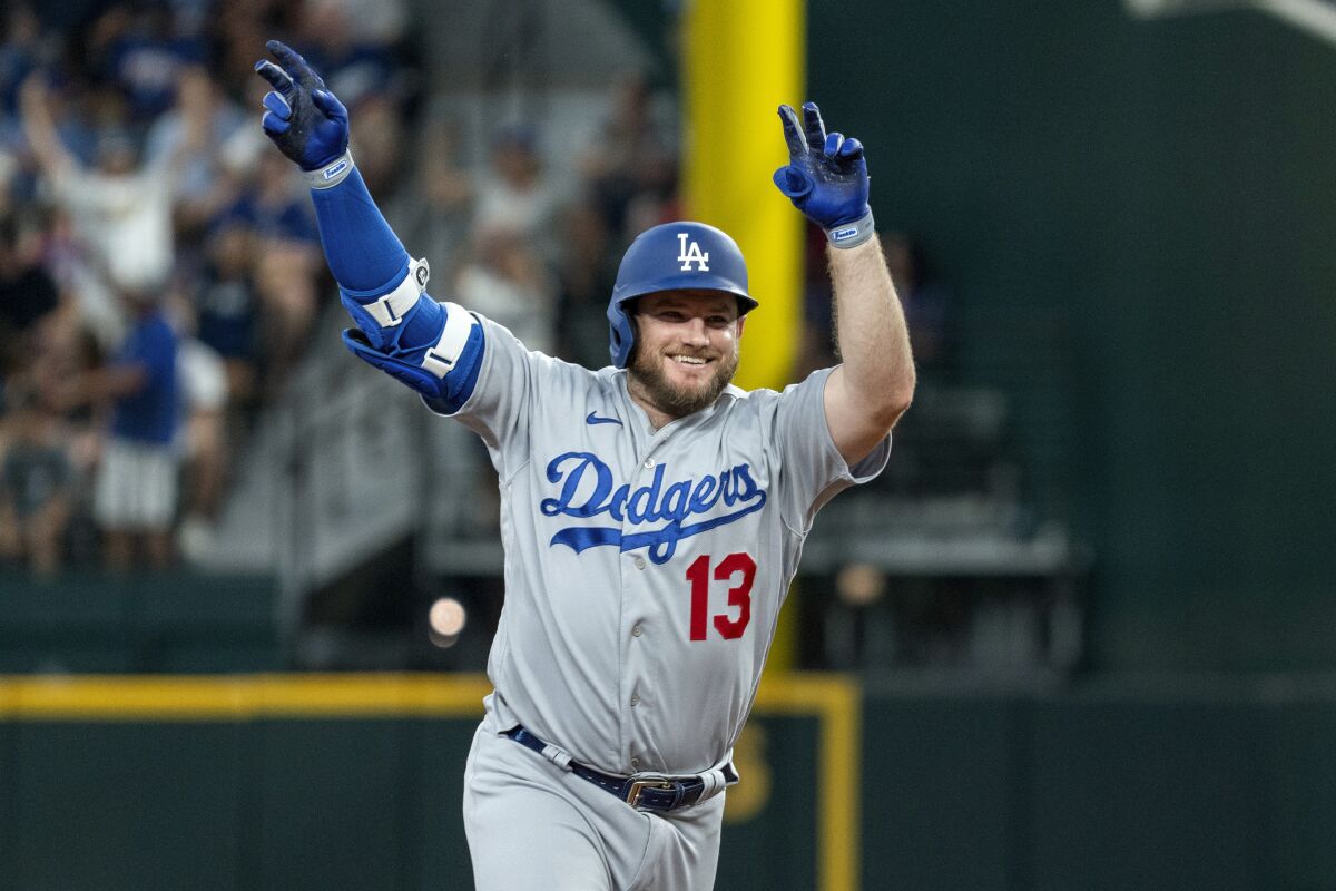 Max Muncy celebrates after hitting a solo home run in the third inning against the Rangers on Saturday.