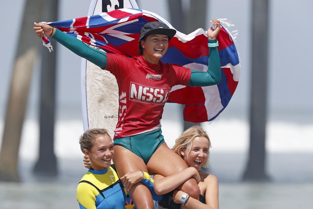 Luana Silva of Hawaii celebrates winning the open women's title at the National Scholastic Surfing Assn. National Championships in Huntington Beach on Wednesday.