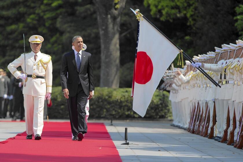 President Obama reviews troops during a welcome ceremony at the Imperial Palace in Tokyo on Thursday.
