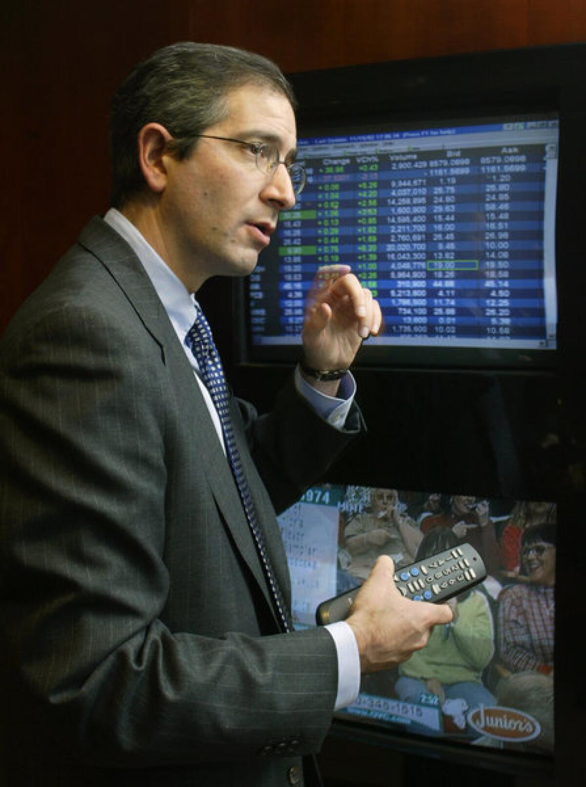 Comcast Corp. Chairman and Chief Executive Brian Roberts demonstrates an early version of video¿on¿demand services in 2002. VOD has finally reached 60% of TV homes in the U.S., according to a new Nielsen study.