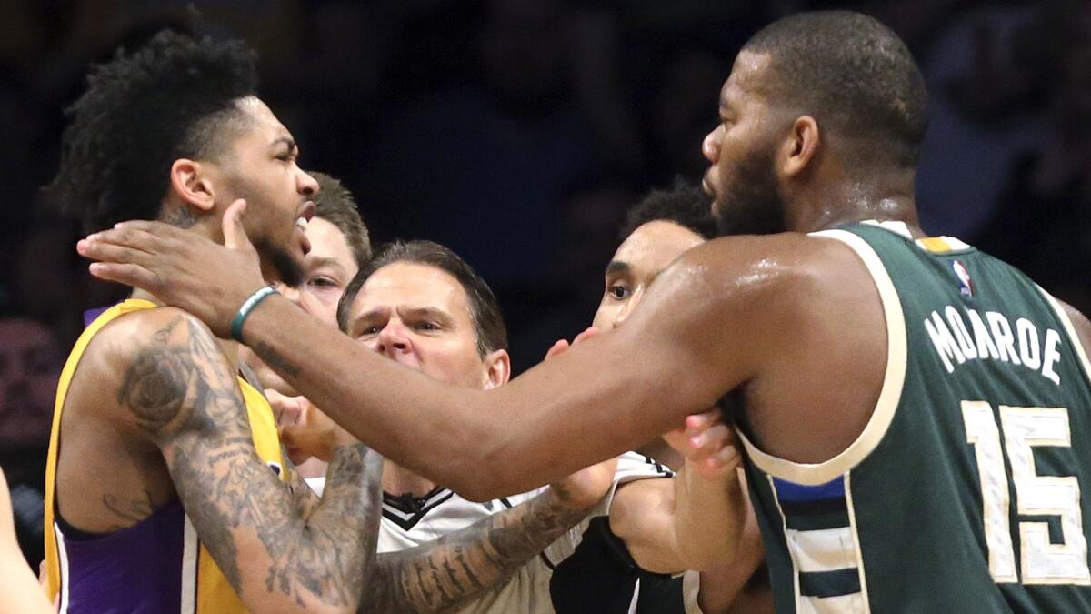 Lakers forward Brandon Ingram, left, and Bucks center Greg Monroe are separated by a referee during an altercation during the third quarter of their game Friday night.