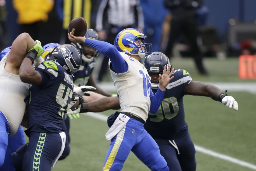 Los Angeles Rams quarterback Jared Goff passes as Seattle Seahawks defensive tackle Jarran Reed.