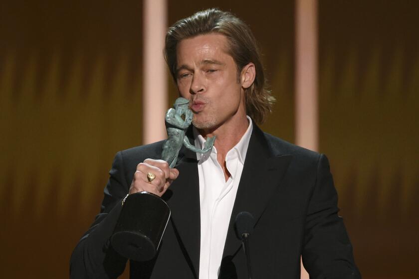 Brad Pitt kisses "The Actor" statuette as he accepts the award for outstanding performance by a male actor in a supporting role for "Once Upon a Time in Hollywood" at the 26th annual Screen Actors Guild Awards at the Shrine Auditorium & Expo Hall on Sunday, Jan. 19, 2020, in Los Angeles. (Photo/Chris Pizzello)