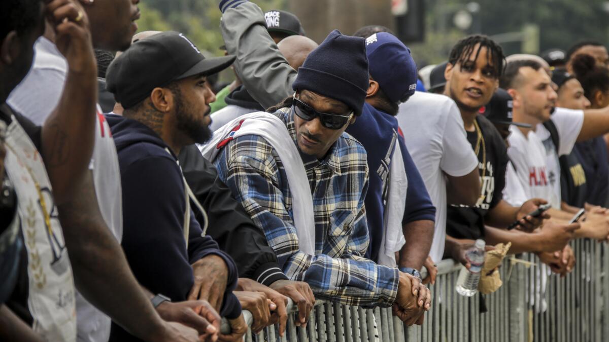 Rapper Snoop Dogg stands outside LAPD headquarters during a peaceful march earlier this month.