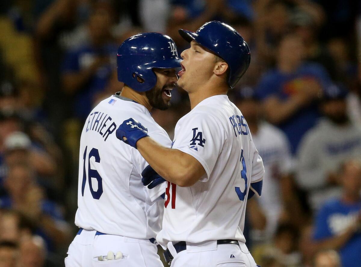 Dodgers outfielders Andre Ethier (16) and Joc Pederson celebrate after Pederson's grand slam against the Giants in the second inning Friday night.