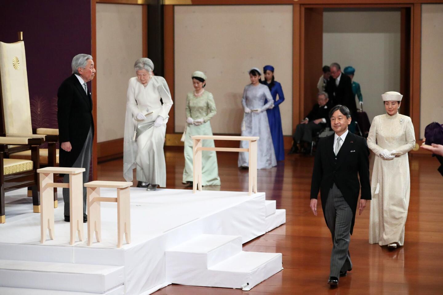 Japanese Emperor Akihito, left, and his wife, Empress Michiko, second from left, are joined by Crown Prince Naruhito, second from right, and his wife, Crown Princess Masako, right, and other members of the royal familily inside the Matsu-no-Ma state room in the Imperial Palace in Tokyo on Tuesday. Emperor Akihito has formally stepped down, the first abdication in more than 200 years in the world's oldest monarchy.
