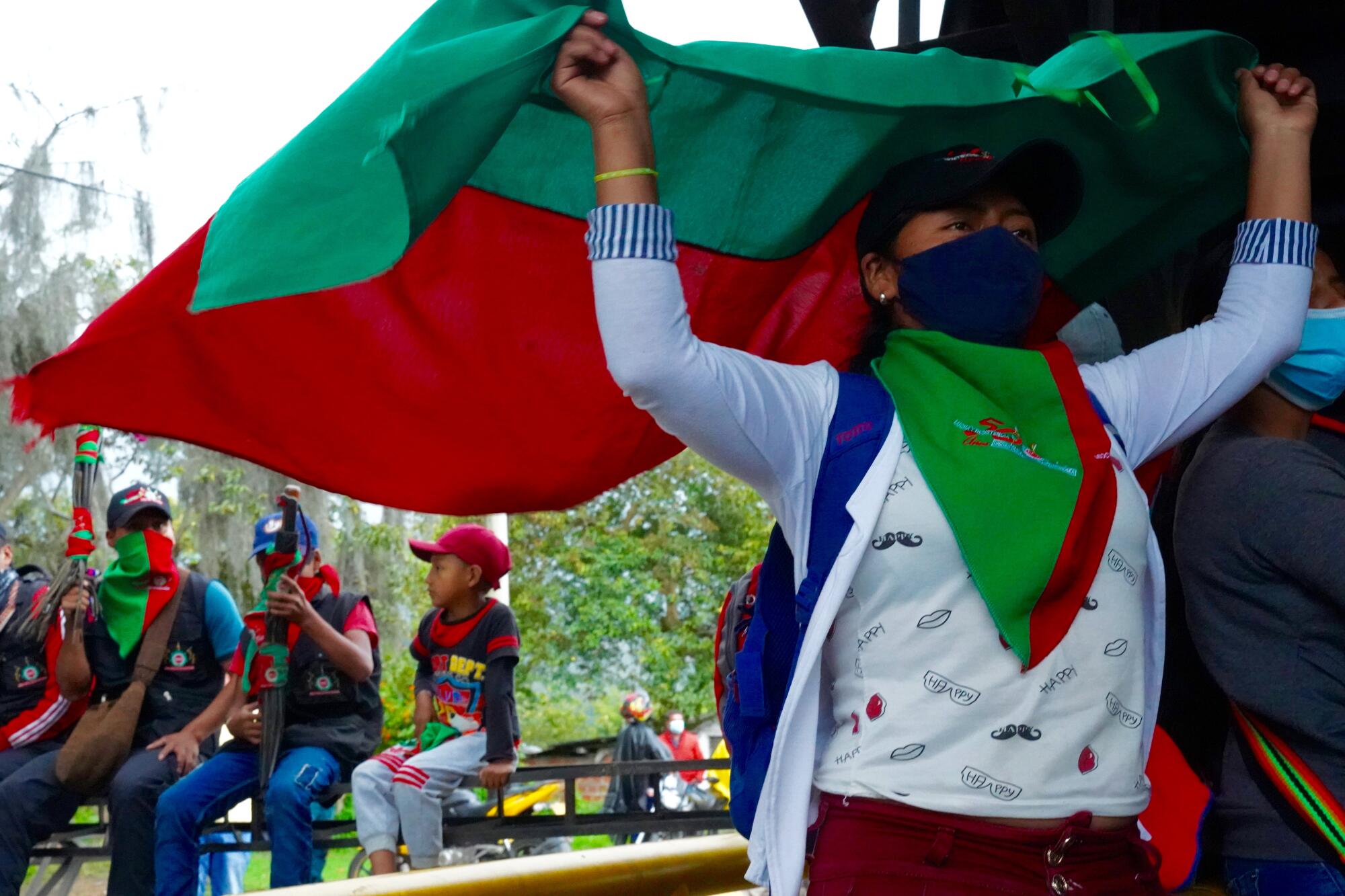 Protesters hold the flag of the Indigenous Council in Cauca on Colombia's Panamerican Highway 