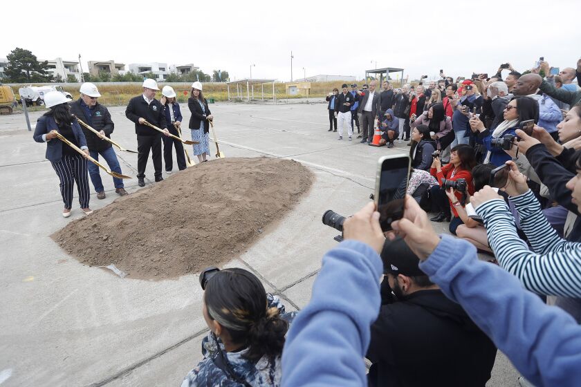 A huge crowd gather around Mayor Farrah Kahn, and council members Larry Agran, Mike Carroll, Tammy Kim, and Kathleen Treseder, from left, as they turn the first dirt during groundbreaking ceremony for newest significant phase of construction at the Great Park in Irvine on Tuesday.