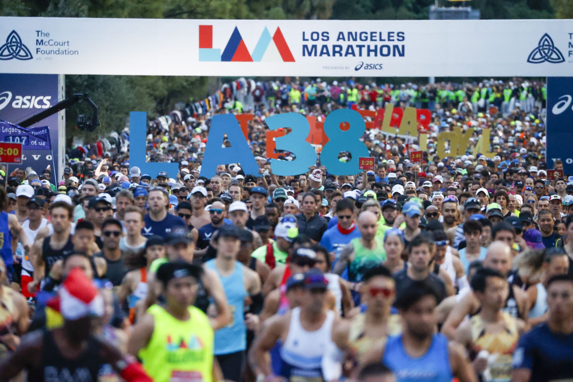 Runners start the 38th L.A. Marathon at Dodger Stadium on Sunday.