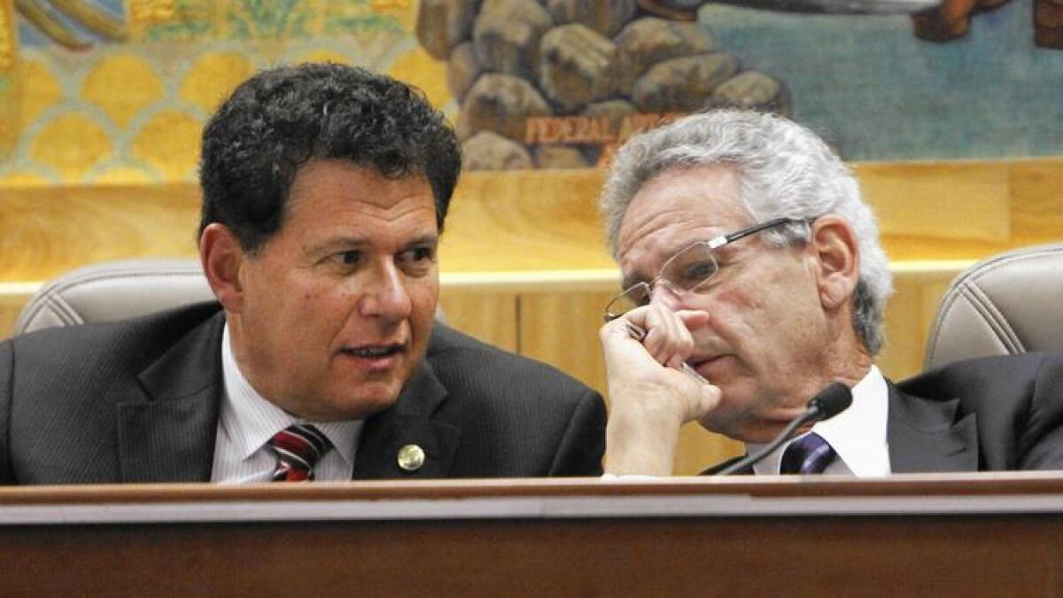 State Sen. Marty Block, left, consults with Rep. Alan Lowenthal during a legislative hearing.