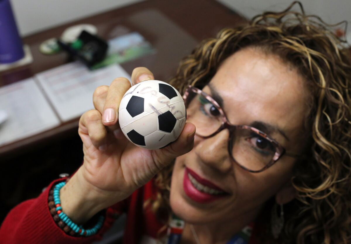 Bertha Alicia Guzman, of Torrance, holds a small soccer ball signed by Mexican professional footballer Jorge Campos.