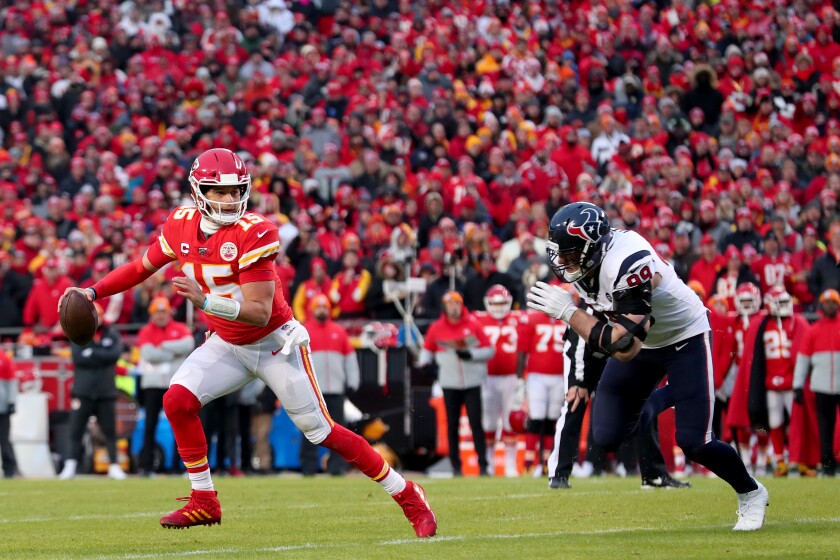 Chiefs quarterback Patrick Mahomes scrambles away from Texans defensive end J.J. Watt during an AFC divisional playoff game on Jan. 12.