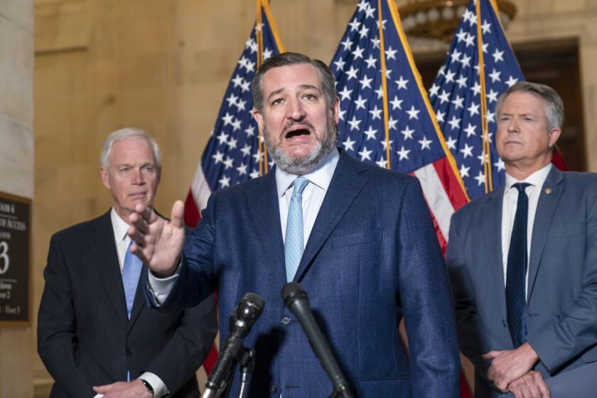 Sen. Ted Cruz, R-Texas, flanked by Sen. Ron Johnson, R-Wis., left, and Sen. Roger Marshall, R-Kan., talks about crime at the Capitol in Washington, Wednesday, Feb. 9, 2022. (AP Photo/J. Scott Applewhite)