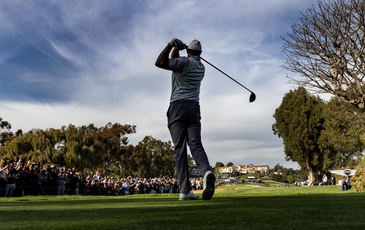 Tiger Woods tees off on the ninth hole at Riviera Country Club on Saturday.