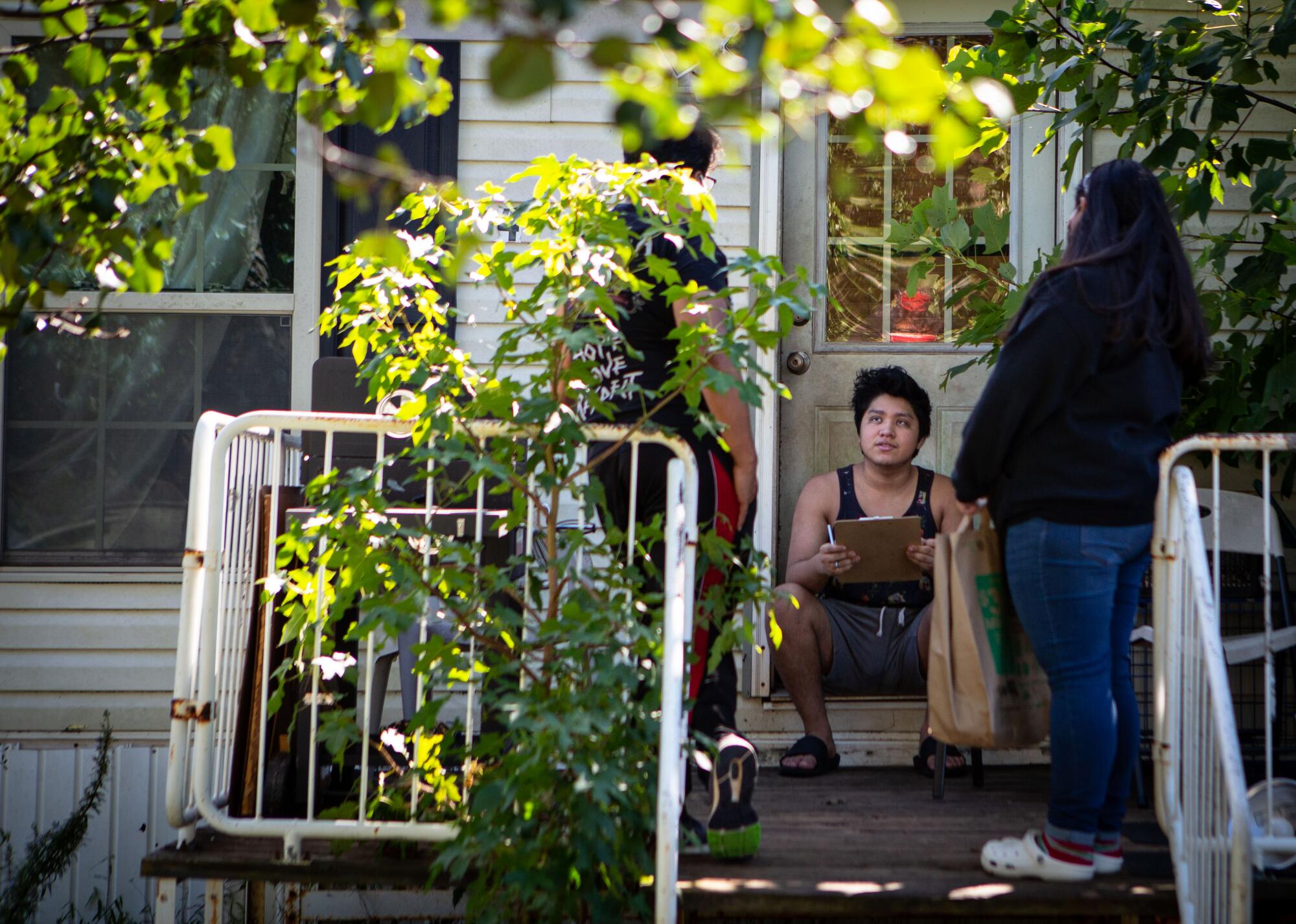 Janet Pulido, right, a member of the group Voto Latino Chatham, registers a voter in Siler City, N.C.