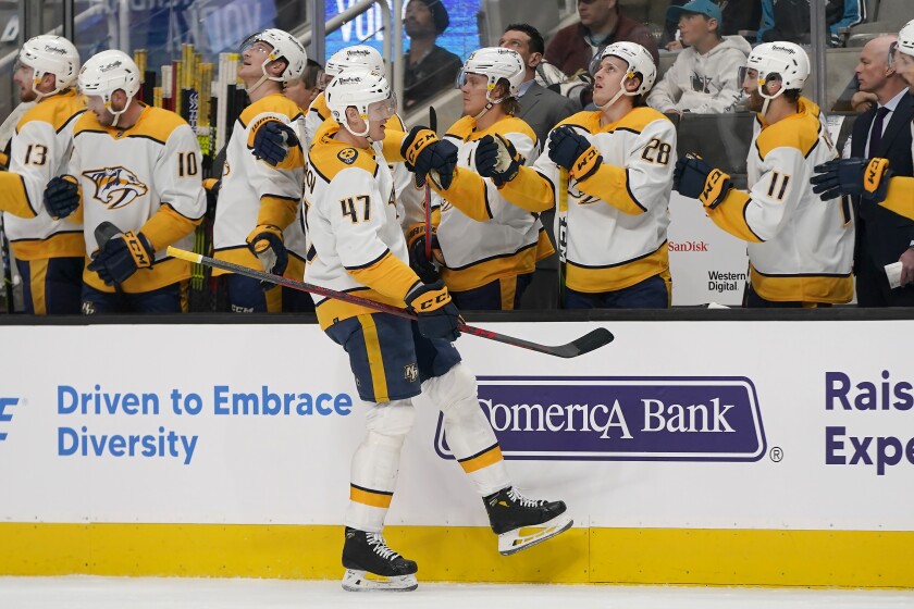 Nashville Predators right wing Michael McCarron (47) is congratulated by teammates after scoring against the San Jose Sharks during the first period of an NHL hockey game in San Jose, Calif., Saturday, March 5, 2022. (AP Photo/Jeff Chiu)