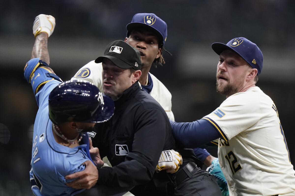 El dominicano José Siri, de los Rays de Tampa Bay, lanza un puetazo a su compatriota Abner Uribe