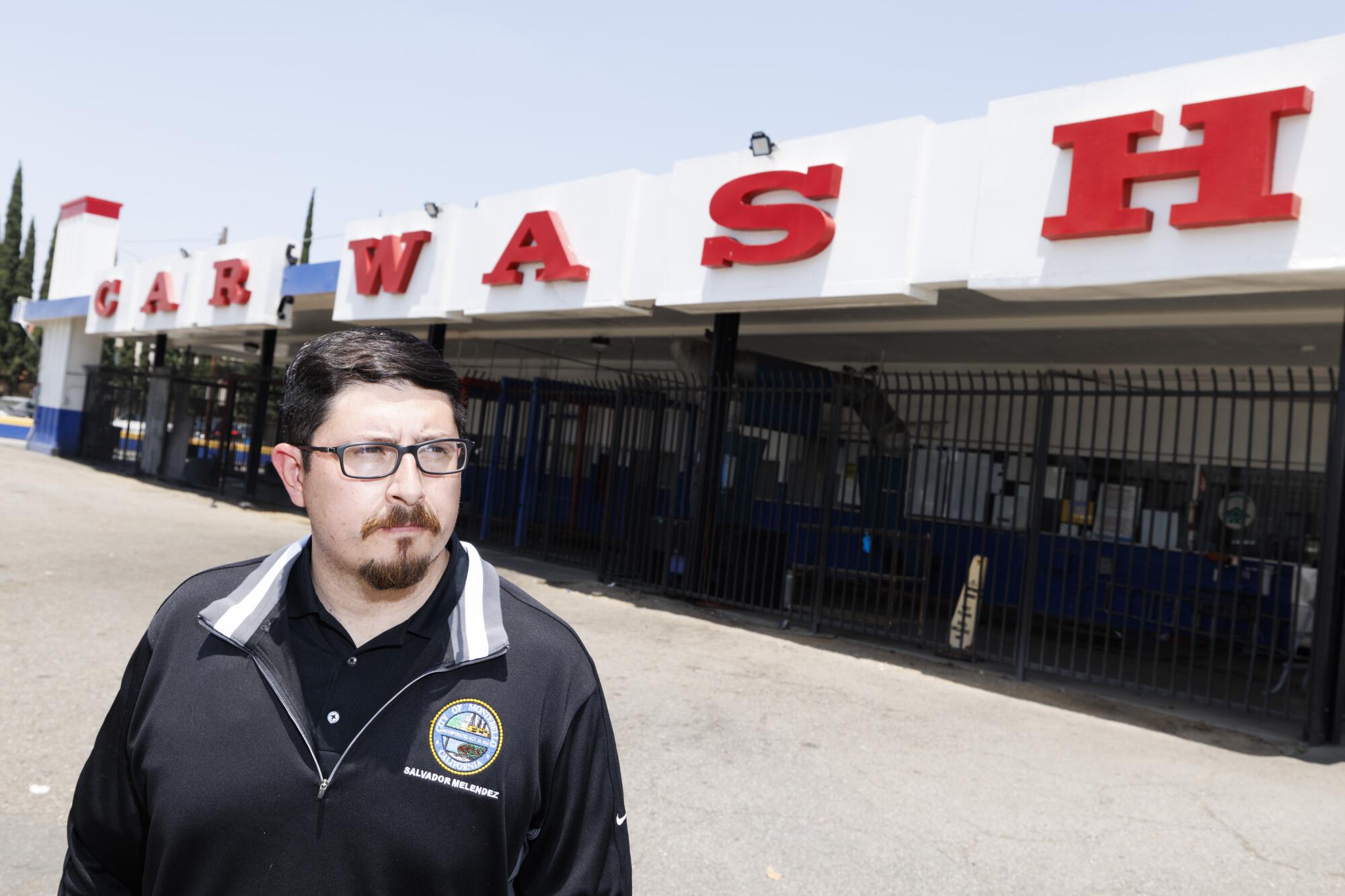 Montebello Mayor Salvador Melendez stands in front of Hand Car Wash