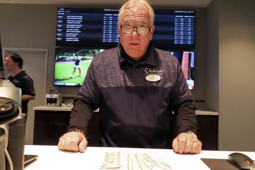 Frank Caltagirone, a sports book employee at the Ocean Casino Resort in Atlantic City, N.J., counts money from his drawer Monday, Feb. 6, 2023. On Feb. 7, 2023, the gambling industry's national trade group, the American Gaming Association, predicted that over 50 million American adults will bet a total of $16 billion on this year's Super Bowl, including legal bets with sports books, illegal ones with bookies, and casual bets among friends or relatives. (AP Photo/Wayne Parry)