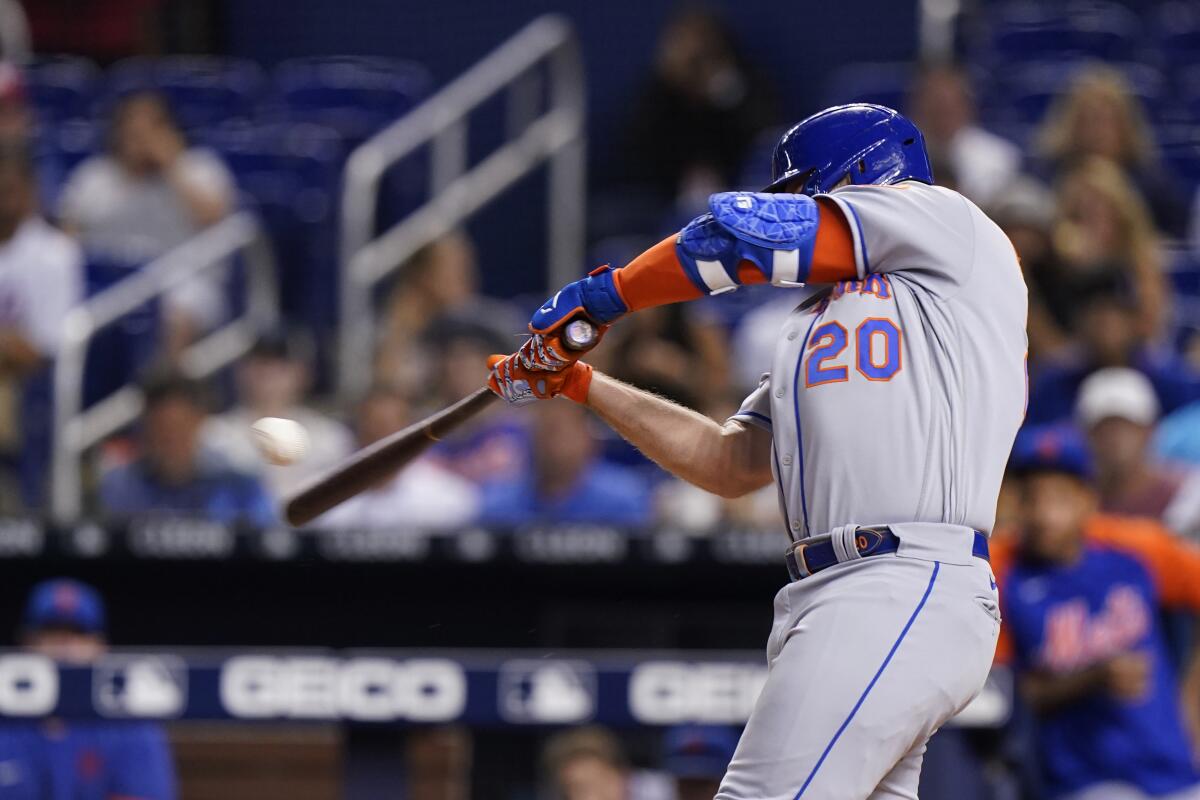 New York Mets' Pete Alonso hits a home run, scoring Francisco Lindor during the first inning of a baseball game against the Miami Marlins, Tuesday, Sept. 7, 2021, in Miami. (AP Photo/Wilfredo Lee)