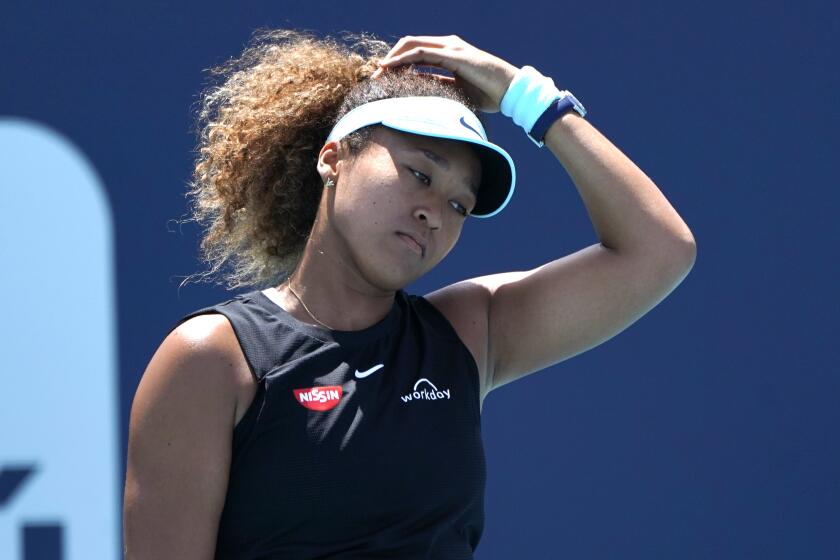 FILE - Naomi Osaka, of Japan, reacts during her match against Maria Sakkari, of Greece, in the quarterfinals of the Miami Open tennis tournament in Miami Gardens, Fla., in this Wednesday, March 31, 2021, file photo. Sakkari won 6-0, 6-4. Naomi Osaka withdrew from the French Open on Monday, May 31, 2021, and wrote on Twitter that she would be taking a break from competition, a dramatic turn of events for a four-time Grand Slam champion who said she experiences “huge waves of anxiety” before speaking to the media and revealed she has “suffered long bouts of depression.”(AP Photo/Lynne Sladky, File)