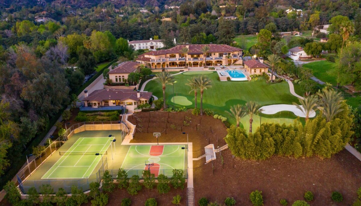 The four-acre estate includes a mansion, guesthouse, swimming pool, tennis court, basketball court and two-hole golf course.