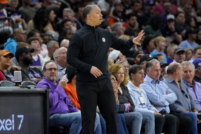 Los Angeles Clippers head coach Tyronn Lue motions to his players during Game 1 of a first-round NBA basketball playoff series against the Phoenix Suns, Sunday, April 16, 2023, in Phoenix. (AP Photo/Matt York)