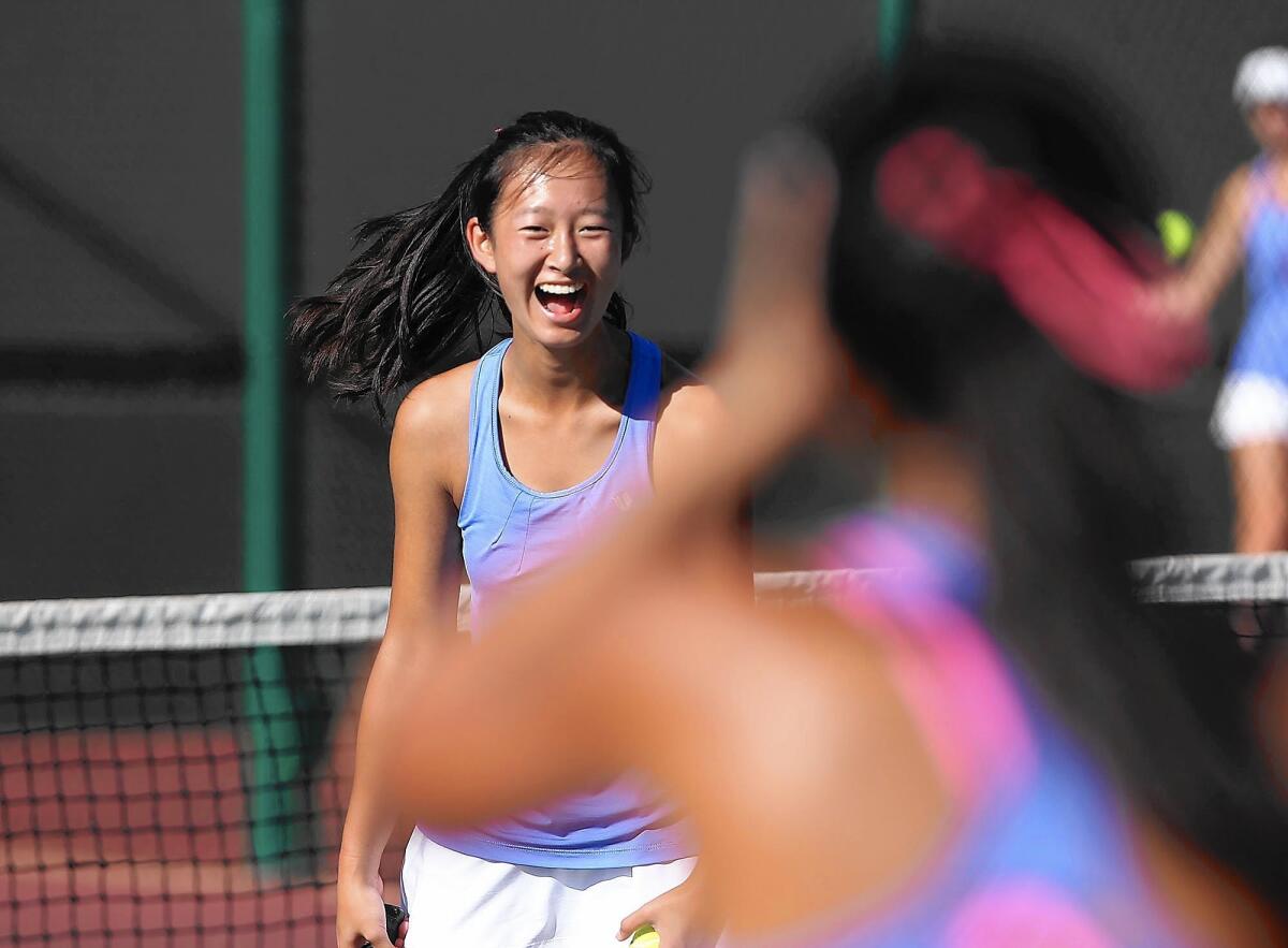 Corona del Mar High's Erica Chen laughs with her partner against Sage Hill on Wednesday.
