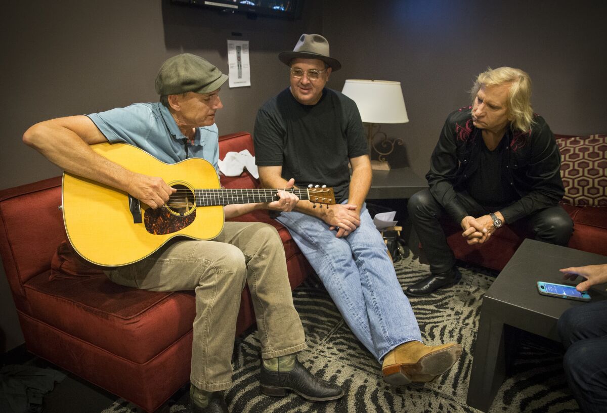 Backstage at the Novo, James Taylor, left, Vince Gill and Joe Walsh share stories about the impact music-making played in their lives growing up.