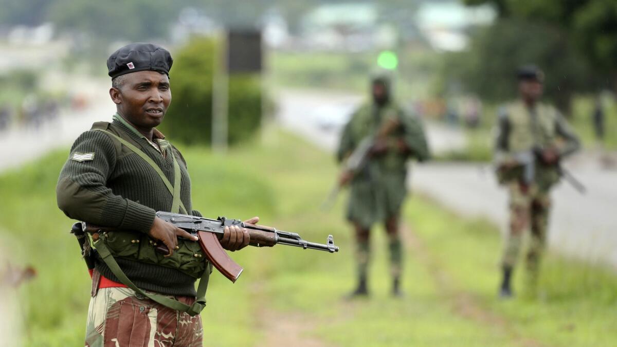 Soldiers patrol as protesters gather during a demonstration over the fuel price hikes in Zimbabwe.