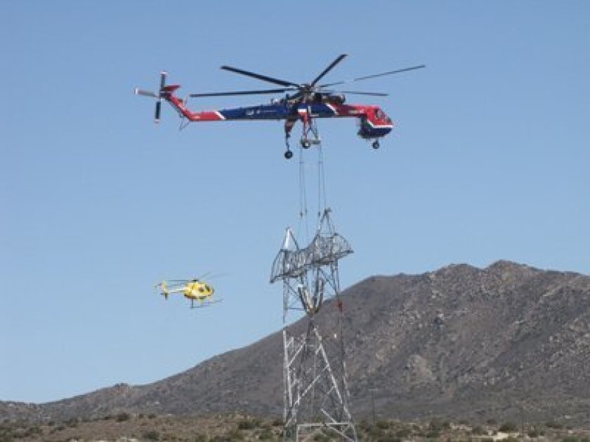 A helicopter transports a section for the Sunrise Powerlink transmission line. Credit: San Diego Gas and Electric