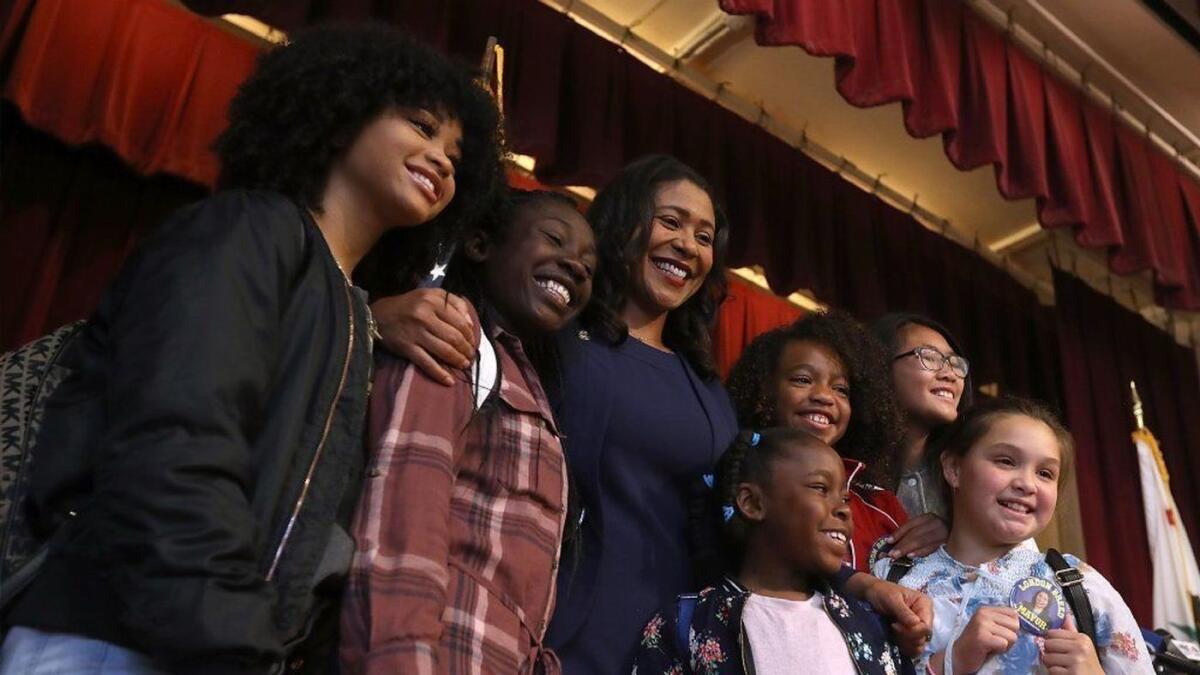 San Francisco Mayor-elect London Breed, center, greets students after a news conference on June 14 in San Francisco.