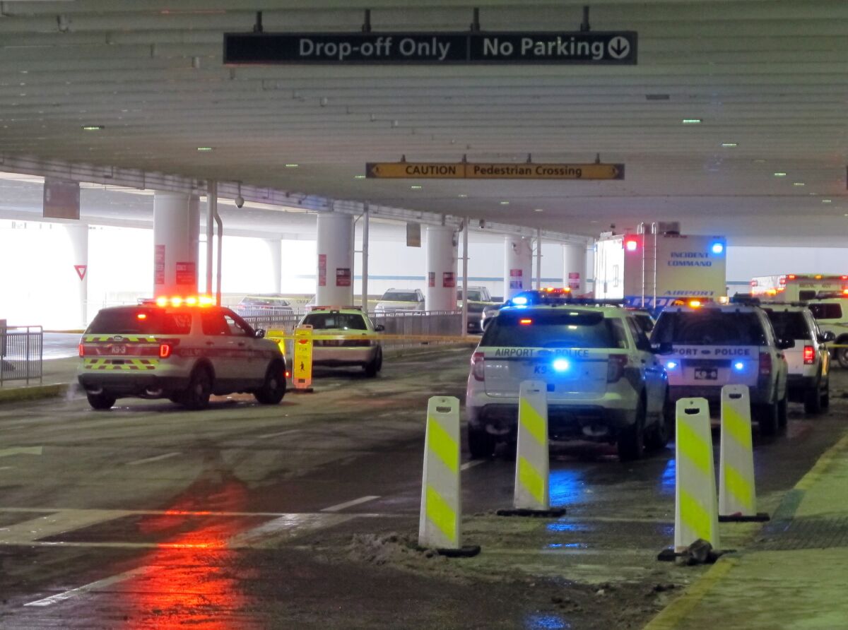 Emergency vehicles converge at the ticketing level at Port Columbus International Airport after officials say an airport police officer shot and killed a man after a confrontation.