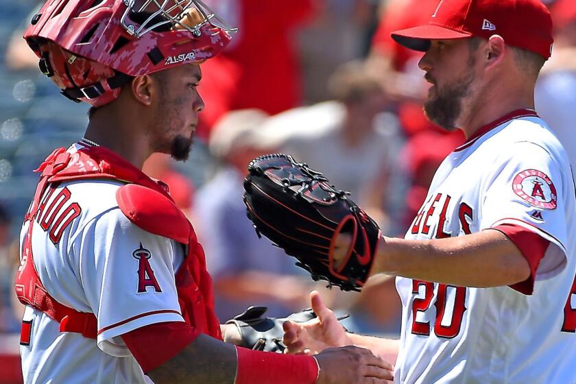 ANAHEIM, CA - JULY 23: Bud Norris #20 of the Los Angeles Angels of Anaheim shakes hands with Martin Maldonado #12 after earning a save in the ninth inning of the game against the Boston Red Sox at Angel Stadium of Anaheim on July 23, 2017 in Anaheim, California. (Photo by Jayne Kamin-Oncea/Getty Images) ** OUTS - ELSENT, FPG, CM - OUTS * NM, PH, VA if sourced by CT, LA or MoD **