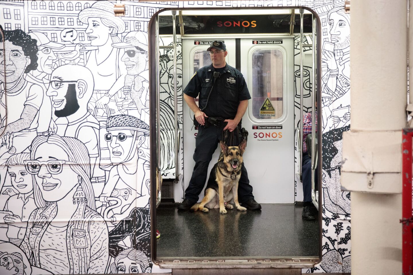 A member of the NYPD K-9 Unit patrols on a subway train between Grand Central Terminal and Times Square in Manhattan.