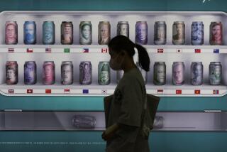 A woman walks by a bank's currency advertisement board in Seoul, South Korea, Friday, Sept. 23, 2022. Asian stocks fell for a third day Friday after more rate hikes by the Federal Reserve and other central banks to control persistent inflation spurred fears of a possible global recession. (AP Photo/Ahn Young-joon)