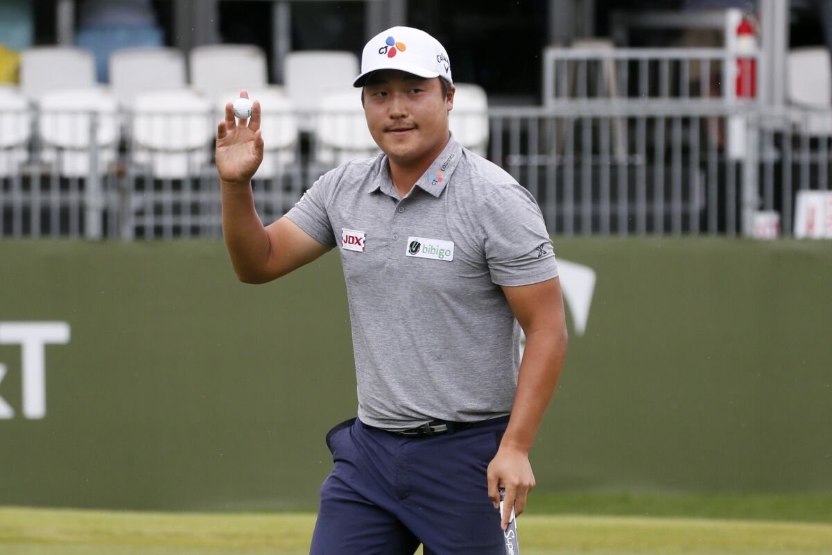 K.H. Lee acknowledges applause from the gallery after sinking a putt on the 17th green.