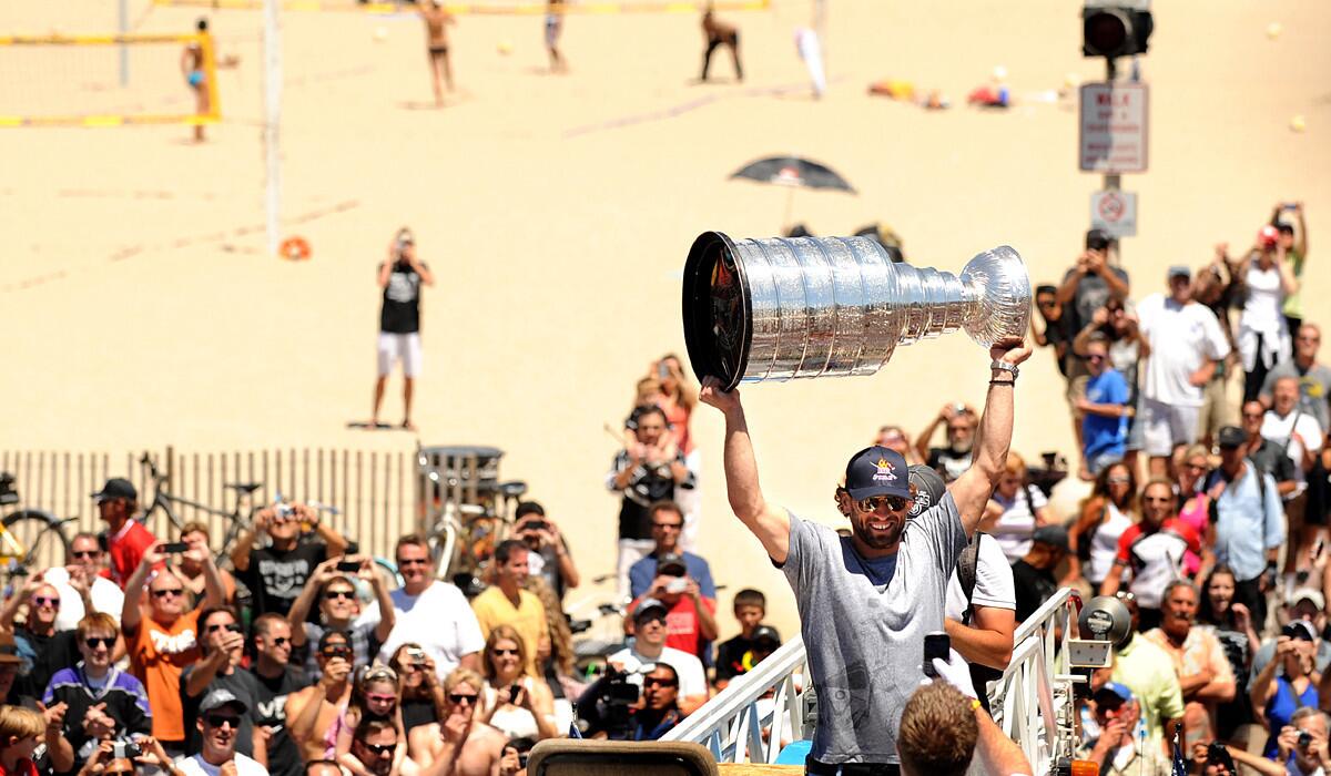Kings center Jarret Stoll raises the Stanley Cup along the strand in Hermosa Beach during a victory celebration.