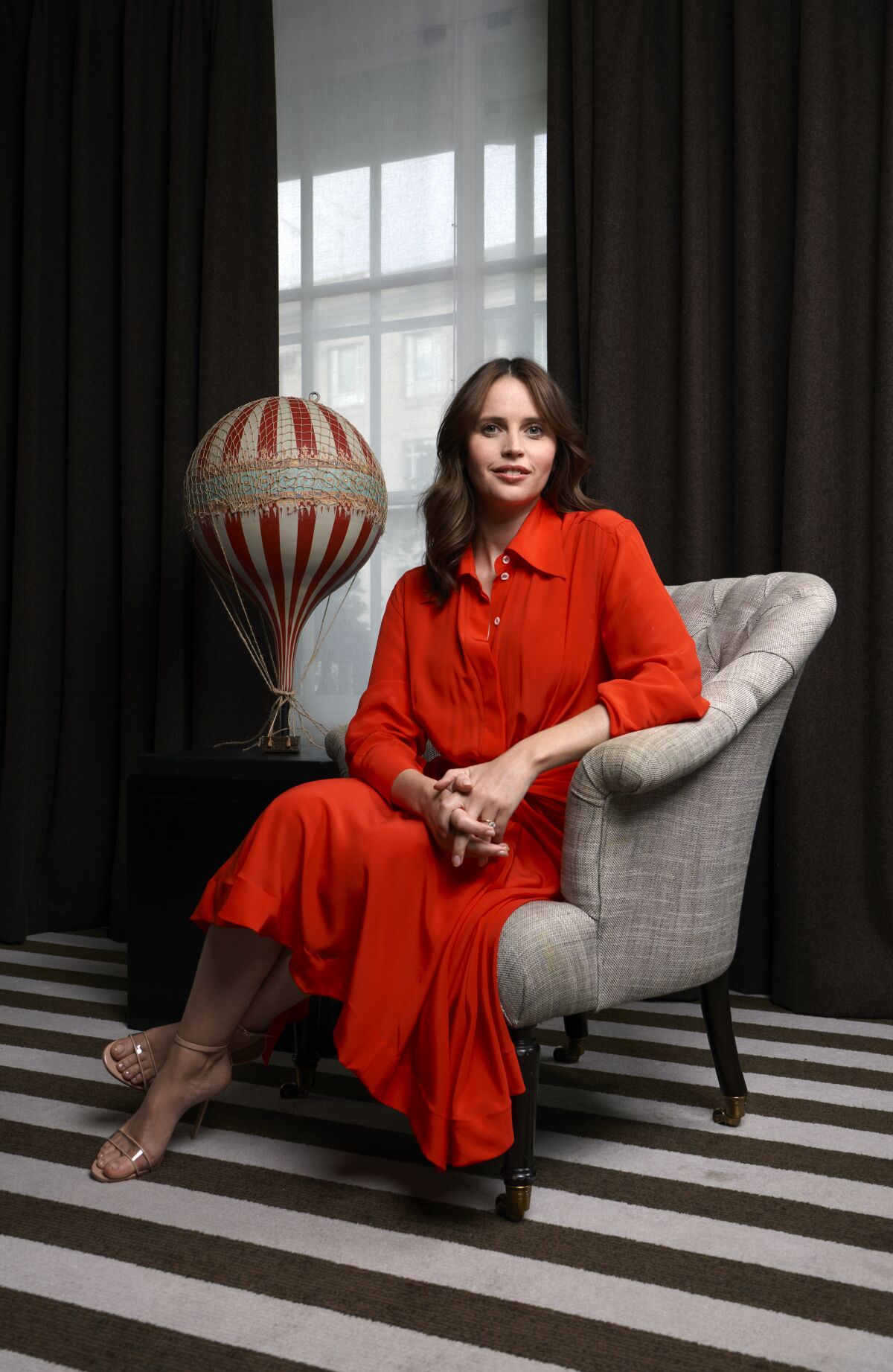 "It’s just ropes and canvas, but the stakes are very high," Felicity Jones says of hot-air ballooning, depicted in “The Aeronauts.” She sits next to a model balloon at a press event in London.