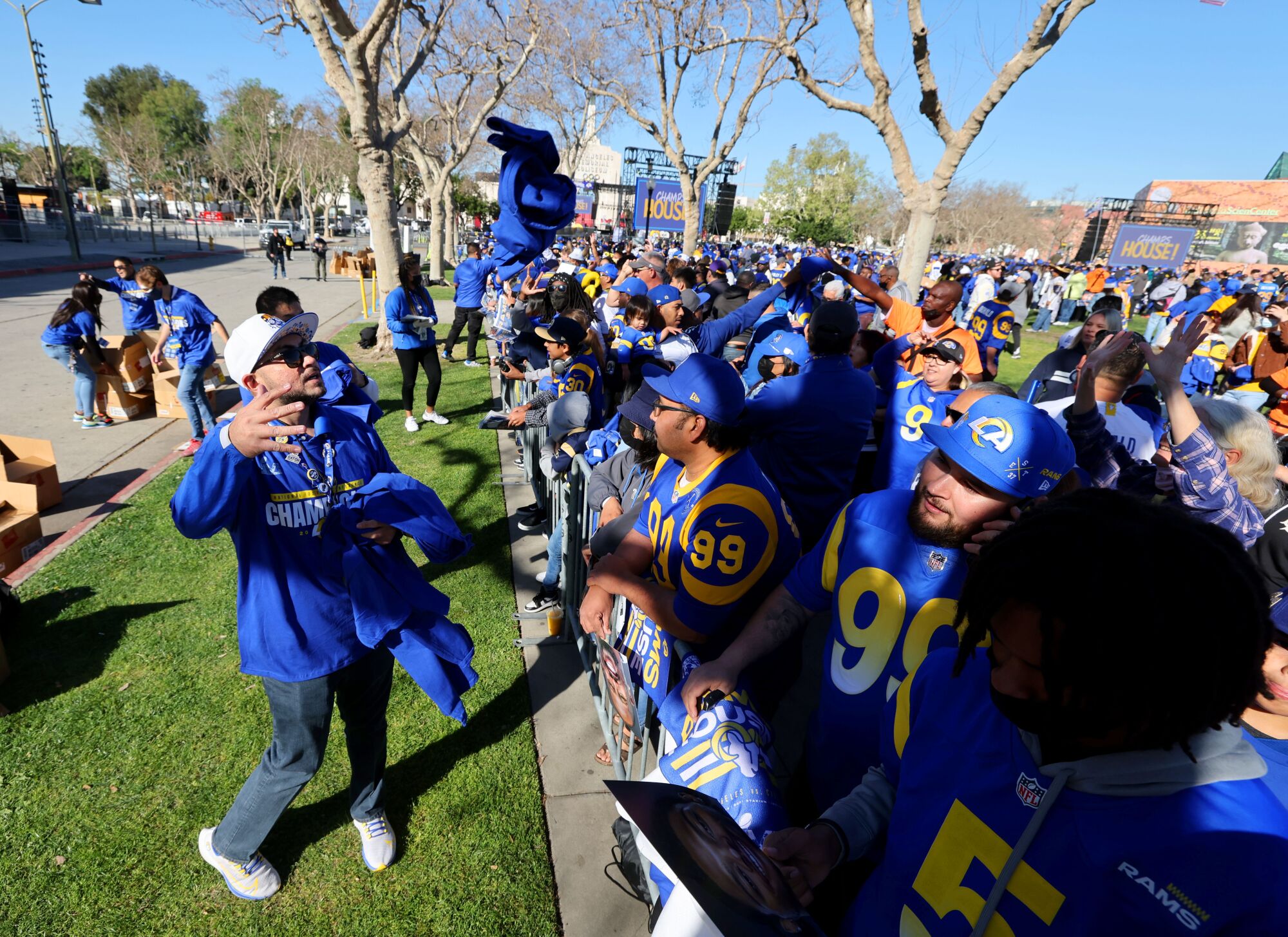 People in Rams gear gather in a park