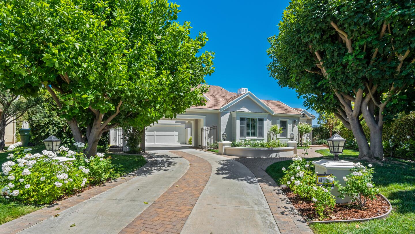 The estate spans half an acre in the guard-gated Oaks of Calabasas neighborhood and centers on a 6,000-square-foot custom home.
