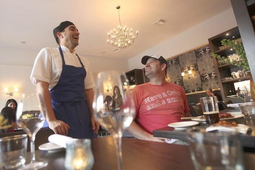 Chef and owner Michael J. Young, left, talks with diner Seth Hancock at the Studio City restaurant. Young formerly was chef at Domenico's in Silver Lake.
